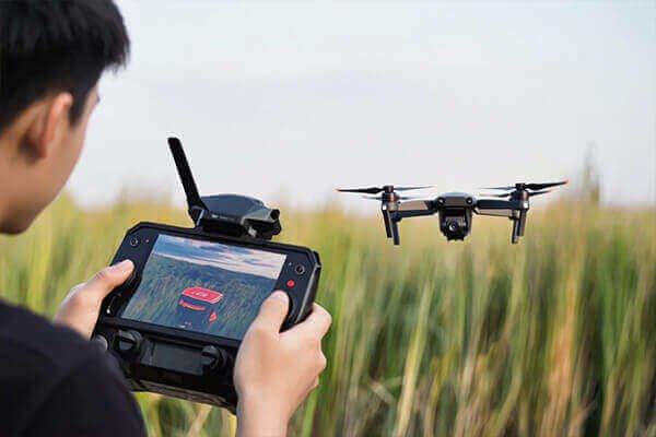 A person transferring drone footage from a microSD card to a rugged external hard drive