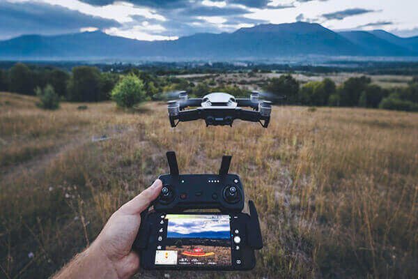 A 128GB microSD card next to a consumer drone
