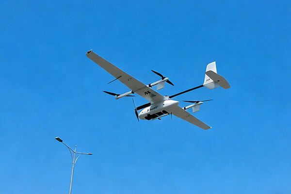 An image showing three different types of UAVs: a multirotor, a fixed-wing, and a VTOL hybrid