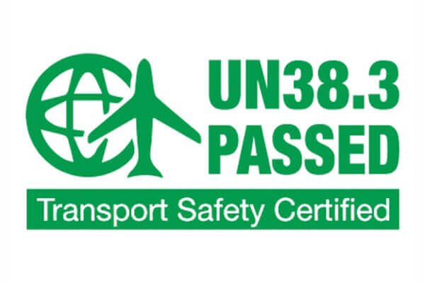 A logistics worker scanning a battery package with UN38.3 and MSDS documentation attached.