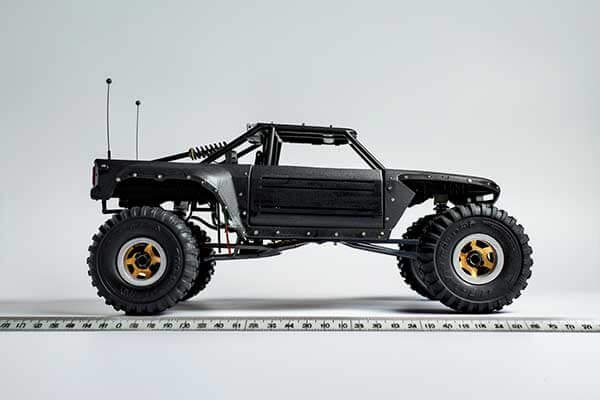 An infographic showing a real car and a 1/8 scale model car with division symbols to illustrate the scaling process.