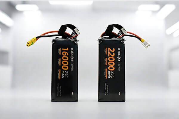 An illustration comparing two glasses: one tall and thin (high voltage, low mAh), the other short and wide (low voltage, high mAh), both holding the same amount of water (Wh)