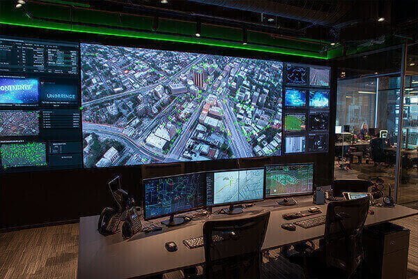 Drone Geofencing Technology A drone approaching a virtual red wall in the sky with a "No-Fly Zone" symbol, unable to proceed.